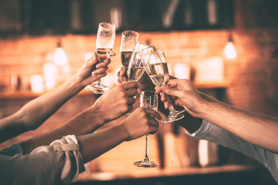 Glasses of sparkling wine raised in a toast