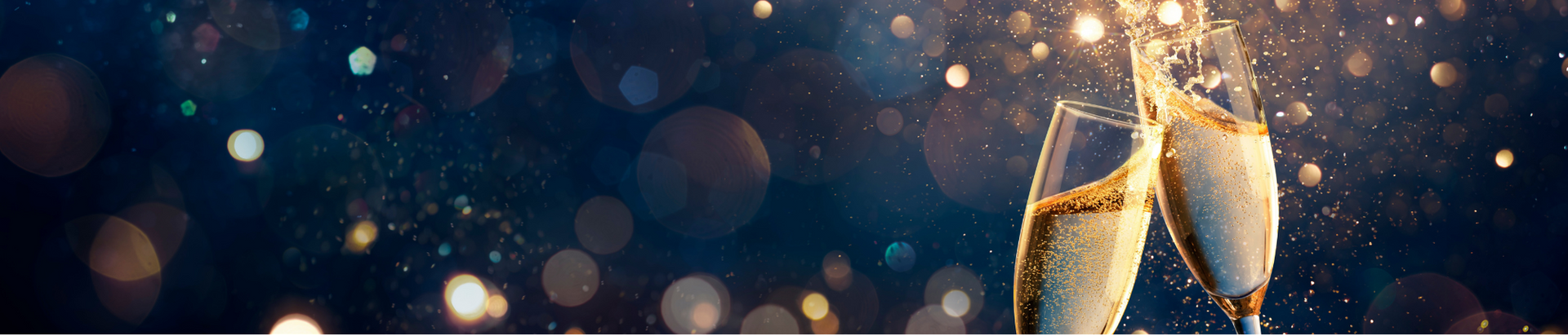 Two champagne glasses clink together with bubbles rising, surrounded by golden, sparkling bokeh lights on a dark, festive background.
