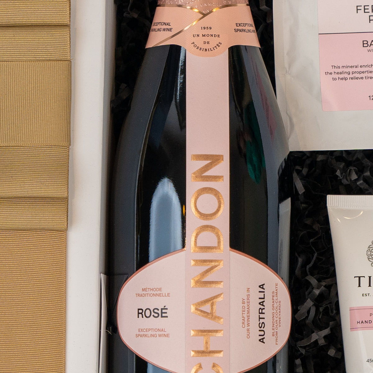 Chandon Rosé Indulgence Hamper: Chandon Rosé with its pink and gold label in black shredded paper