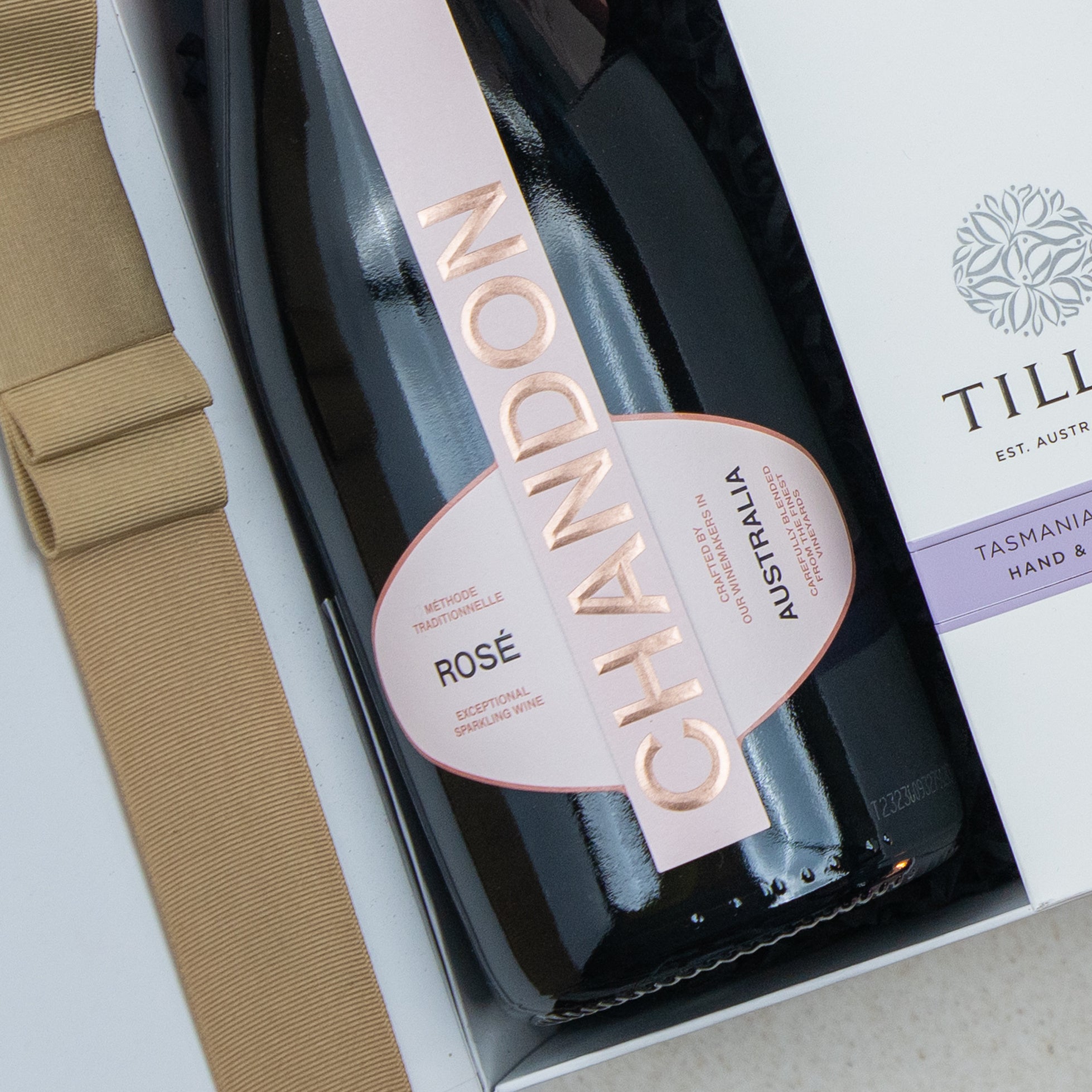 A Chandon Rosé Luxury Selection Hamper by The Hamper Boutique Co, in its gift box, is partially visible beside a beige ribbon and Till brand packaging.