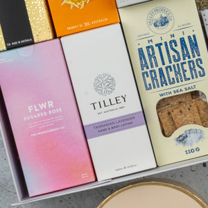 A close-up of the Premium Tea Experience Hamper by The Hamper Boutique Co, featuring an elegant arrangement of assorted tea blends and gourmet treats in a gift box.
