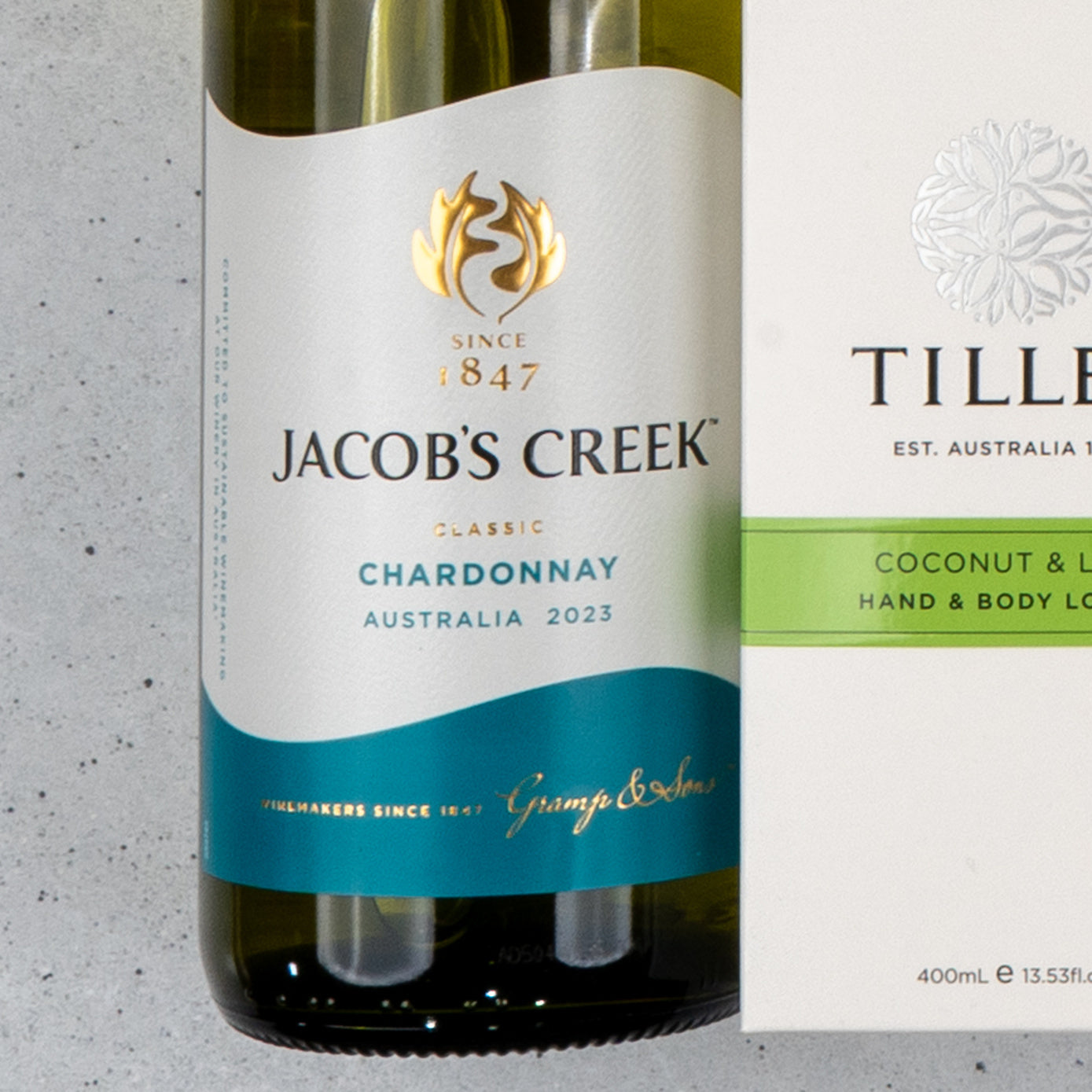 A White Wine and Self-Care hamper by The Hamper Boutique Co, featuring Jacobs Creek Classic Chardonnay 2023 and Tilley coconut & body lotion, both with partially visible labels.