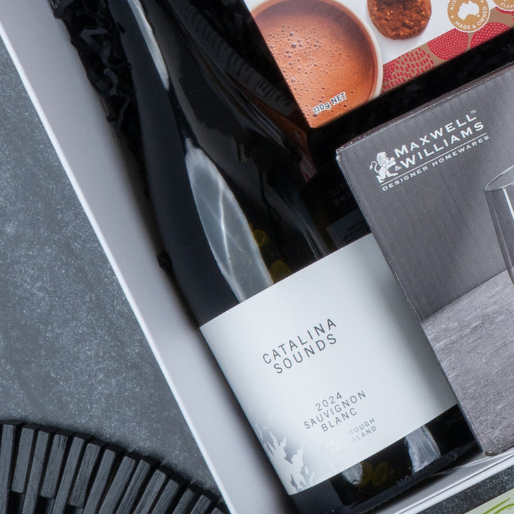 The Hamper Boutique Co Epicurean Delights Hamper includes a Catalina Sounds 2021 Sauvignon Blanc, Maxwell & Williams glassware, and a cookie package—perfect for gifting.