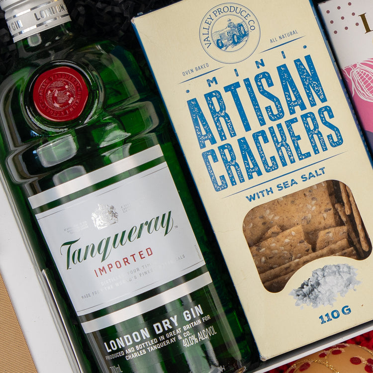 The Hamper Boutique Co Cheers & Tonic gift box includes a bottle of gin and a box of sea salt mini artisan crackers.