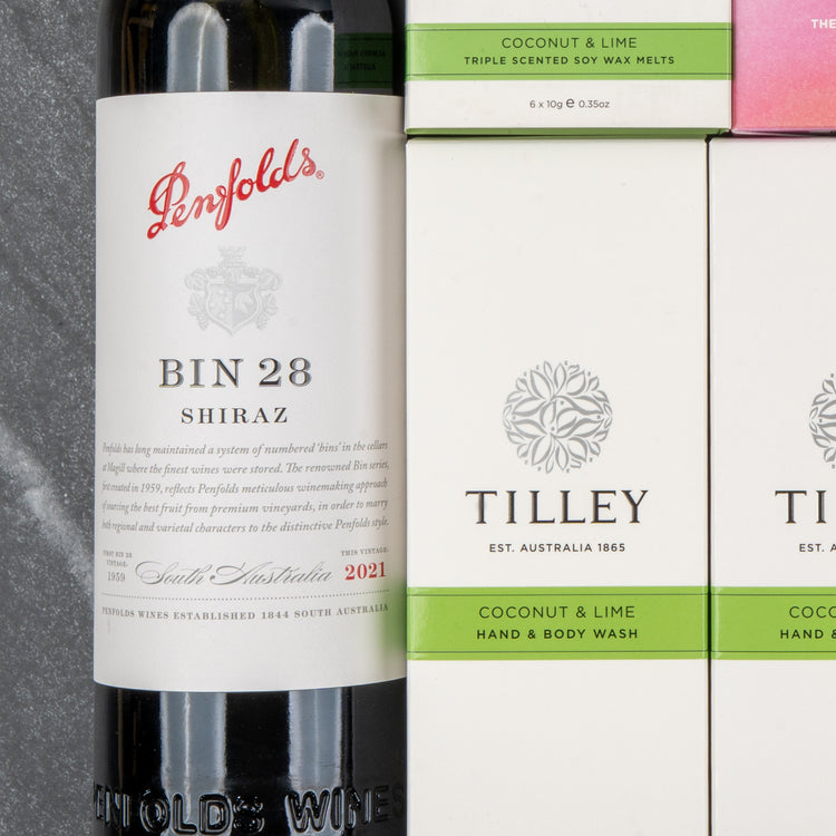 The Hamper Boutique Co's Penfolds Spa and Indulgence Hamper, featuring wine and luxurious wash, is displayed on a gray surface.