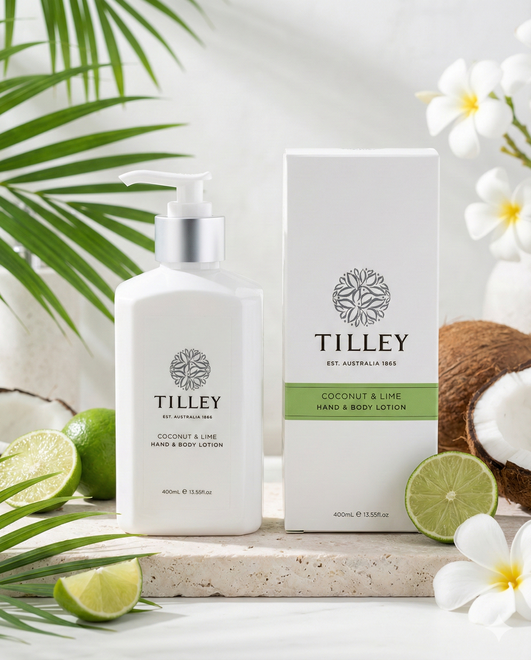 A white Tilley Coconut and Lime Hand and Body Lotion bottle and box rest on a light surface with coconut halves, lime slices, green leaves, and white flowers for a fresh tropical vibe.