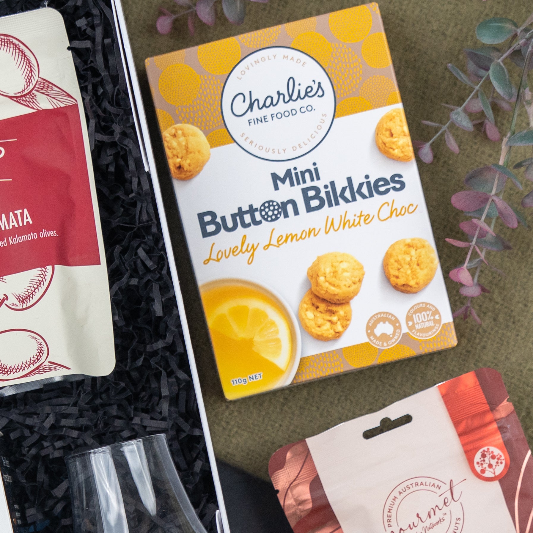 Charlie's Lovely Lemon White Choc Mini Button Bikkies, 110 grams - Delicious lemon-flavoured biscuits with white chocolate buttons, perfect for a sweet treat.