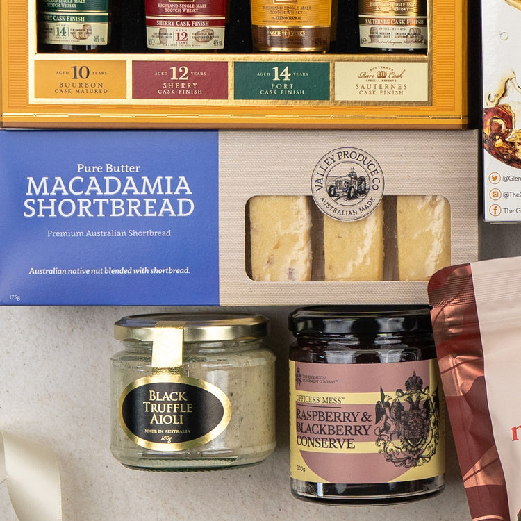The Hamper Boutique Co’s Glenmorangie Ultimate Tasting Hamper features macadamia shortbread, black truffle aioli, raspberry & blackberry conserve, and crackers, all elegantly arranged in a premium gift box.