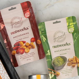 A Tanqueray Gin Journey Hamper from The Hamper Boutique Co is displayed, featuring a branded box with an assortment of gourmet treats and a bottle of Tanqueray gin.
