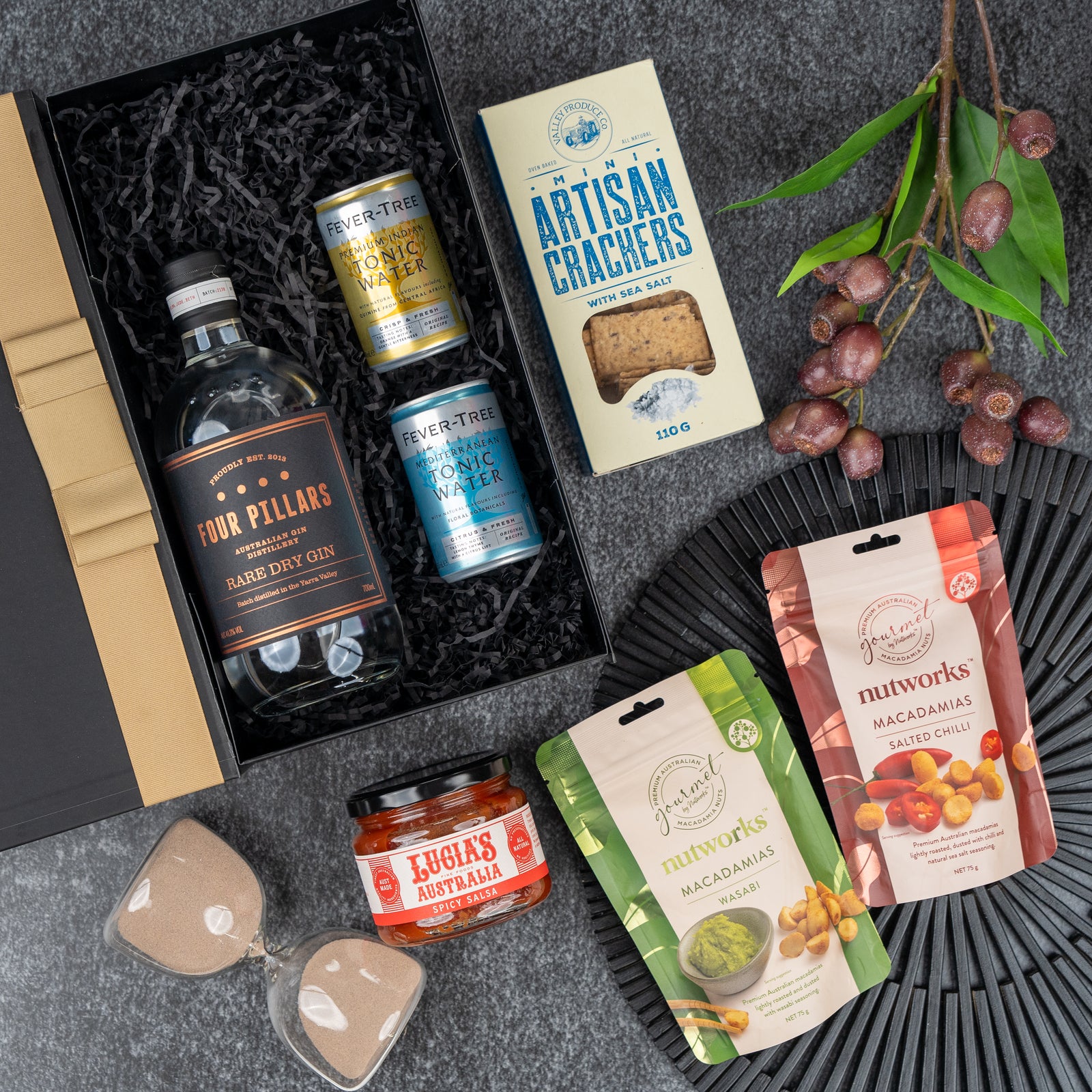 The Hamper Boutique Co’s Four Pillars Discovery Hamper features Four Pillars gin, two Fever-Tree tonic cans, artisan crackers, Lucias relish, and Nutworks macadamias, beautifully arranged for a gourmet gift experience.