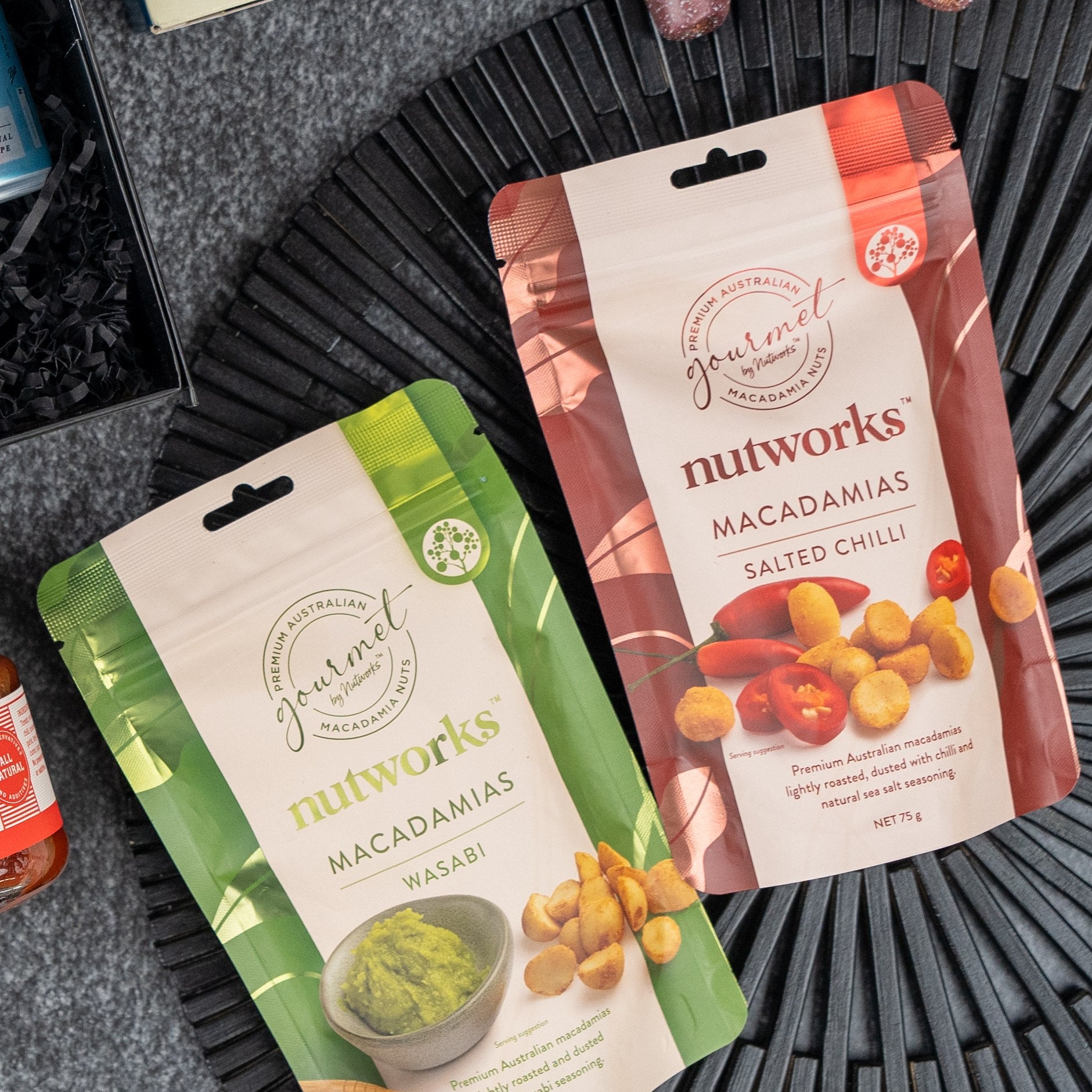 Two Four Pillars Discovery Hamper boxes from The Hamper Boutique Co on a dark surface, both featuring the brand's logo and images of included gourmet items on the front.