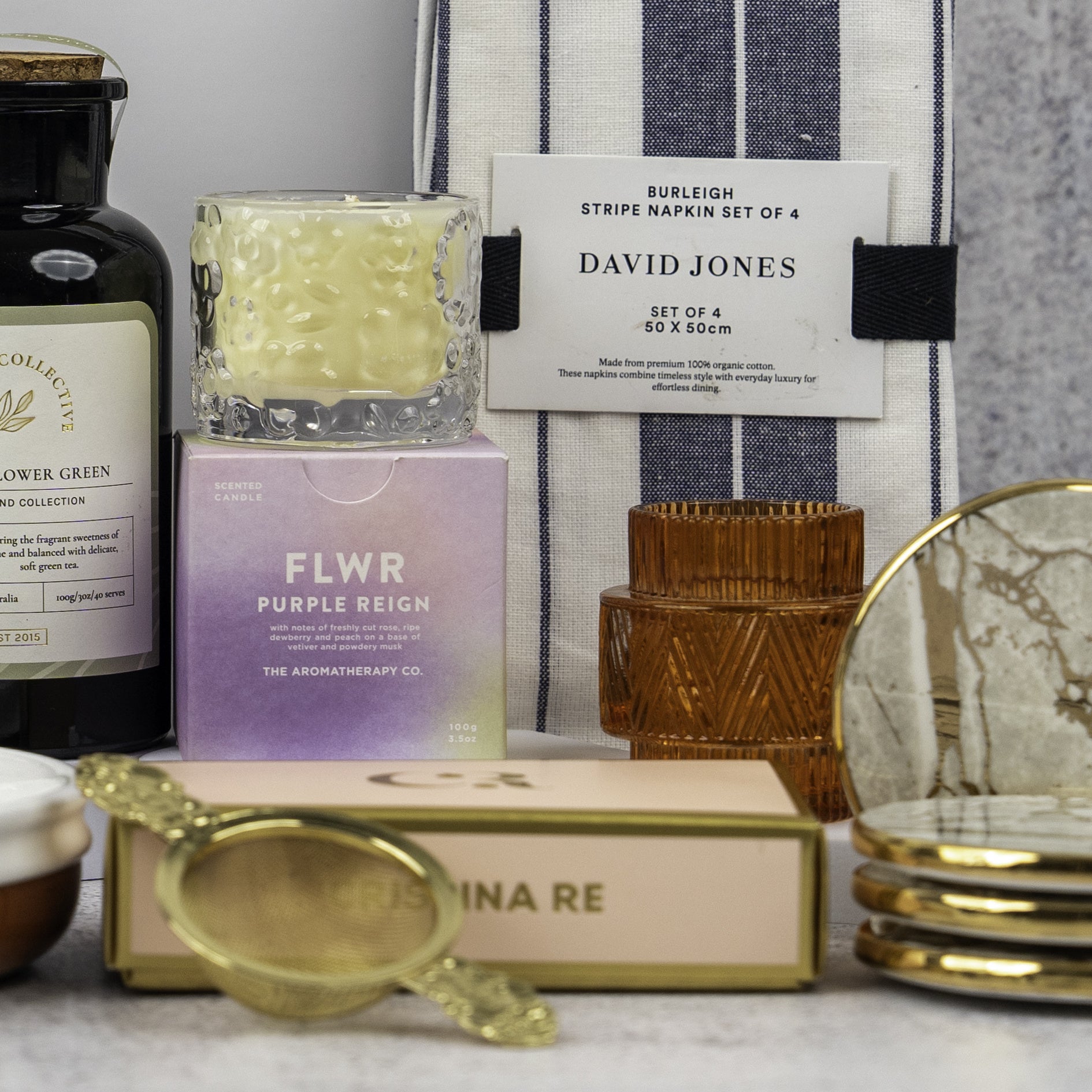 The Hamper Boutique Co's Stylish Home Entertaining Hamper, featuring home and self-care essentials, is beautifully arranged on a white surface.