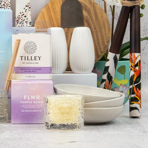 The Hamper Boutique Co's Ultimate Homeware Gift Hamper features candles, incense, ceramic bowls and vases, lavender soap, and a wooden cutting board—all beautifully arranged for stylish home decor and self-care.