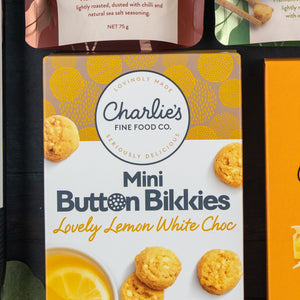 A Festive Treats Gift Hamper by The Hamper Boutique Co, featuring white packaging with yellow accents and images of round cookies.