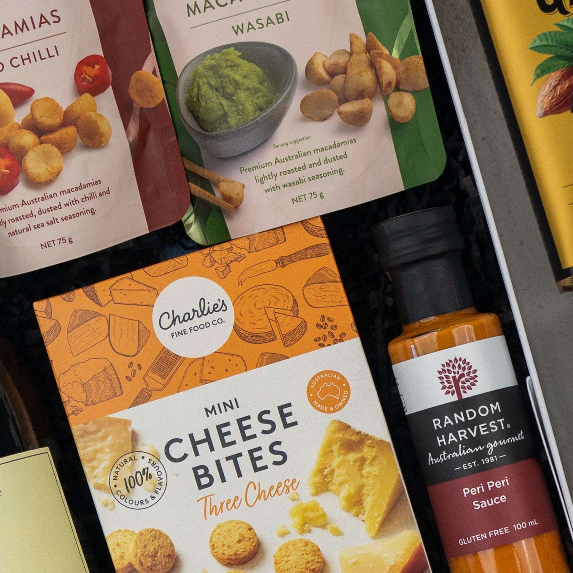 The Hamper Boutique Co’s Red Wine Gourmet Collection Hamper features premium treats and a bottle of red wine, all elegantly presented in sleek black packaging—perfect for gifting.