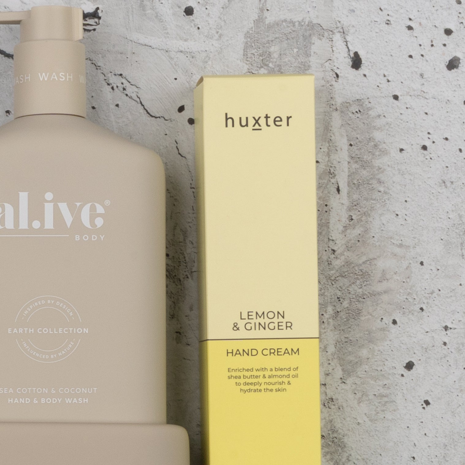 The Hamper Boutique Co's Indulgent Evening Escape features a beige body wash bottle and a yellow hand cream box, displayed side by side against a speckled gray background.