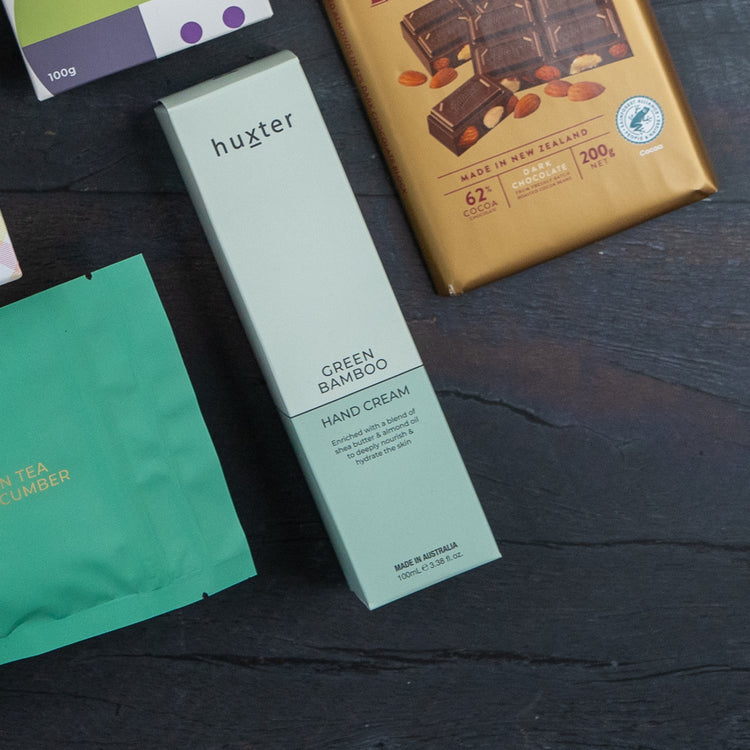 A flat lay of assorted products on a dark surface, featuring The Hamper Boutique Co’s Red Wine Culinary Experience Hamper.