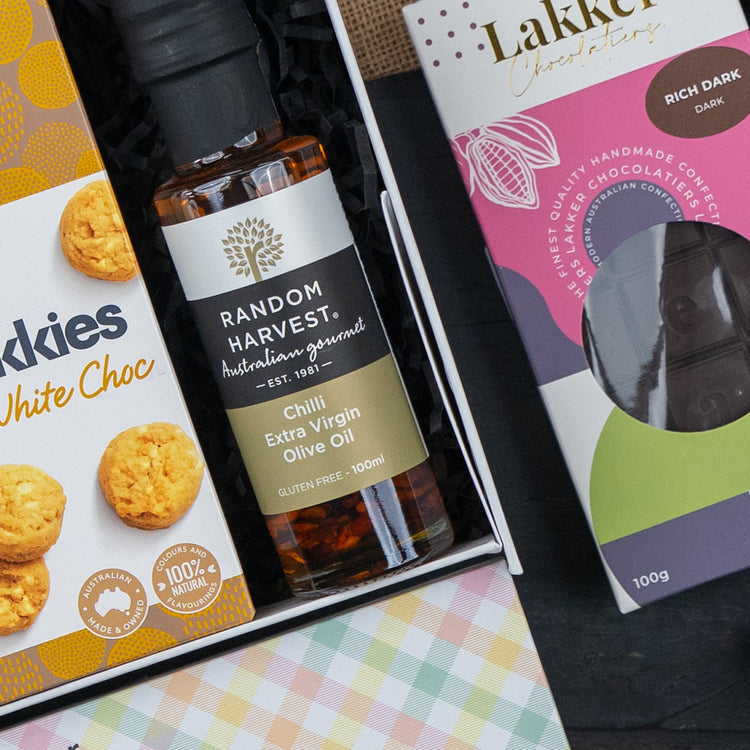 The Hamper Boutique Co’s Red Wine Culinary Experience Hamper features premium treats and is beautifully arranged in festive packaging—perfect for gifting.