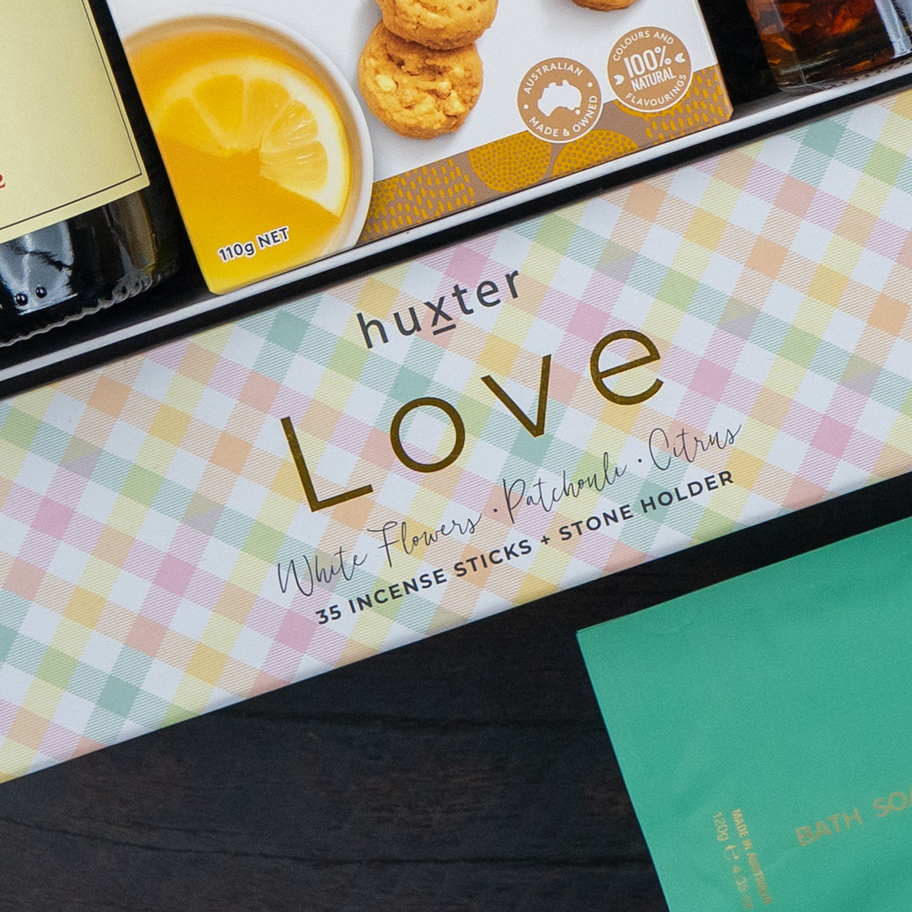A Red Wine Culinary Experience Hamper from The Hamper Boutique Co, featuring a curated selection paired with red wine, is displayed alongside other colorful product packages.