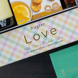 A Red Wine Culinary Experience Hamper from The Hamper Boutique Co, featuring a curated selection paired with red wine, is displayed alongside other colorful product packages.