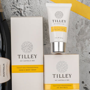 The Chandon Bubbles and Treats Hamper from The Hamper Boutique Co is displayed on a gray textured surface with yellow accents and a partial view of a wine bottle.