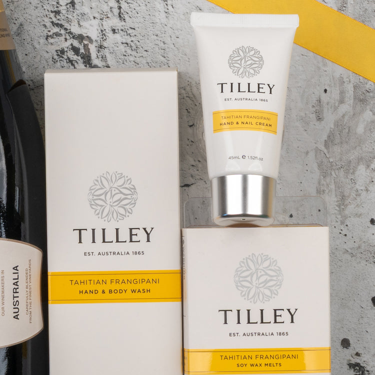 The Chandon Bubbles and Treats Hamper from The Hamper Boutique Co is displayed on a gray textured surface with yellow accents and a partial view of a wine bottle.