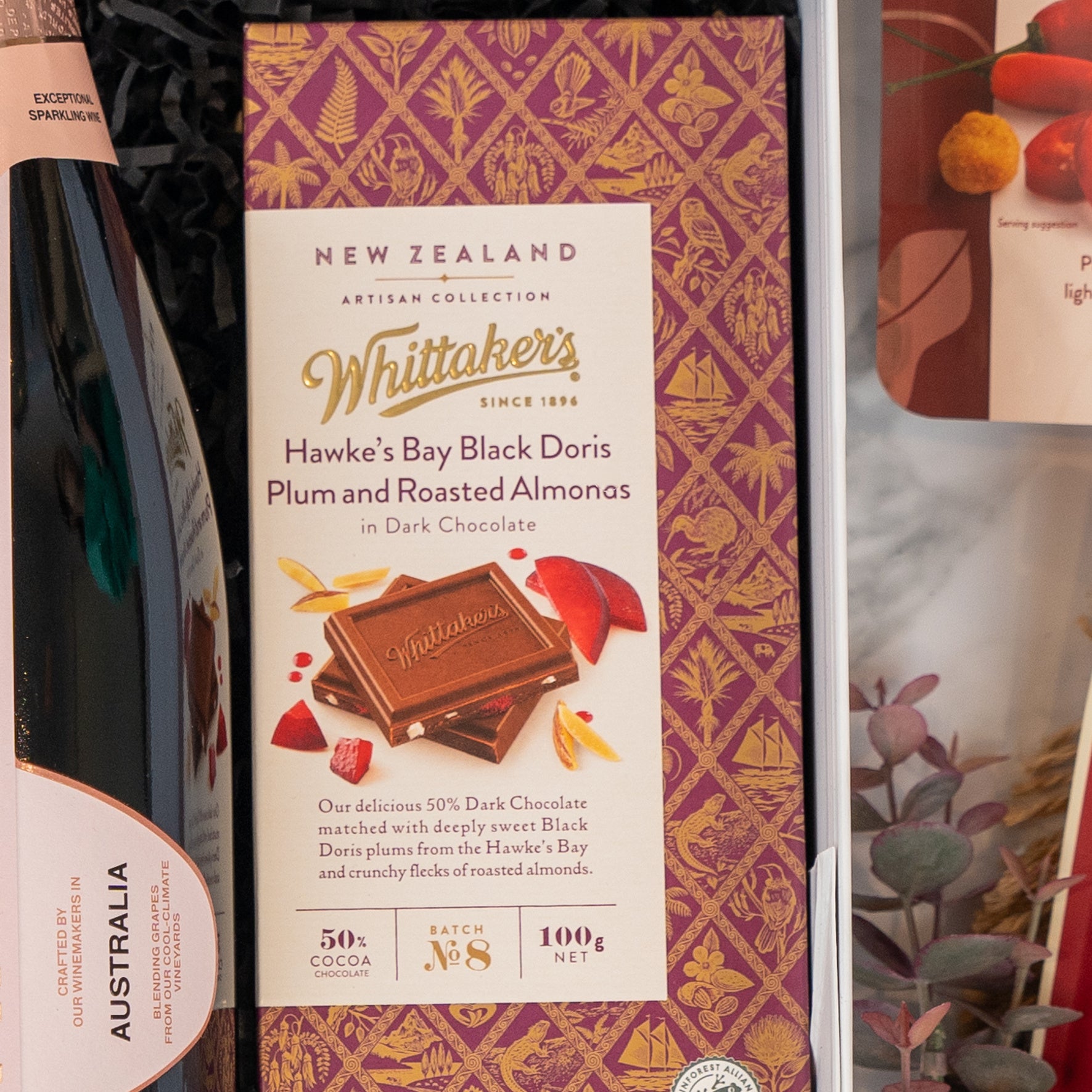 A close-up of The Hamper Boutique Co’s Chandon Rosé Celebration Hamper, featuring elegant packaging, displayed beside a bottle of wine labeled Australia.