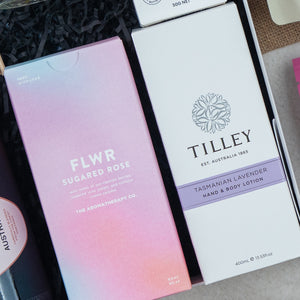 A close-up of two boxed products from The Hamper Boutique Co’s Chandon Connoisseur's Selection Hamper, neatly arranged in a gift box.