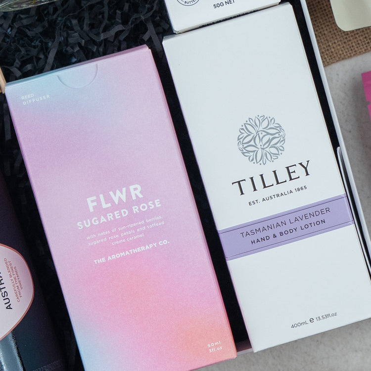 A close-up of two boxed products from The Hamper Boutique Co’s Chandon Connoisseur's Selection Hamper, neatly arranged in a gift box.