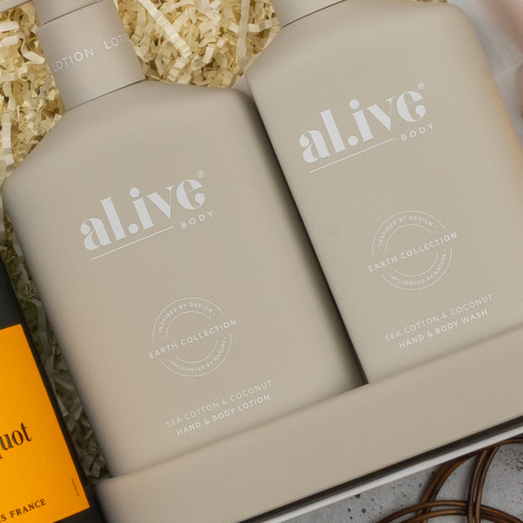 The Hamper Boutique Co's Veuve Clicquot Premium Celebration Hamper is displayed in a gift box with shredded paper filling.