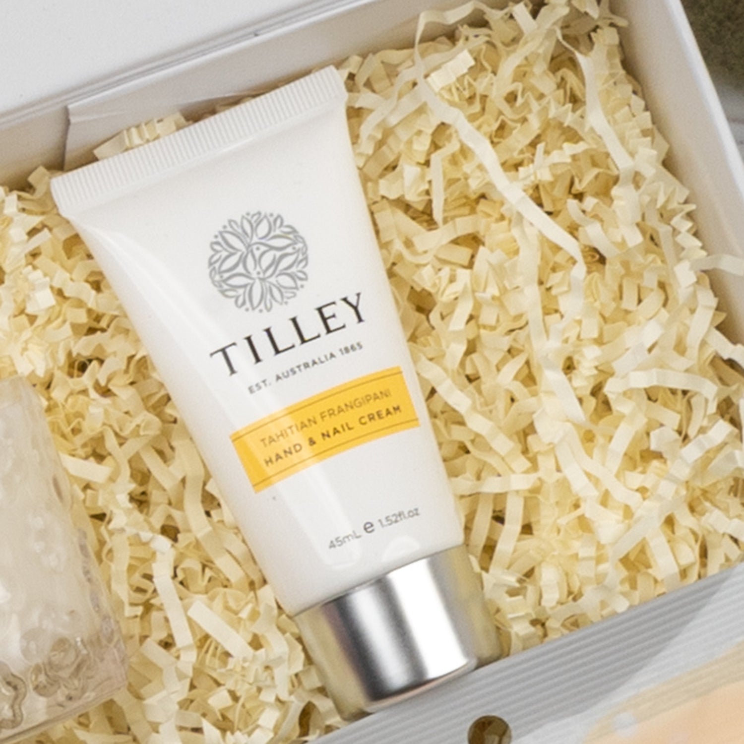 A Veuve Clicquot Premium Celebration Hamper by The Hamper Boutique Co sits on shredded paper packaging inside a gift box.