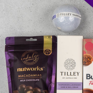 A close-up of The Hamper Boutique Co Tea Lover's Essentials Hamper, displayed on a light grey surface.
