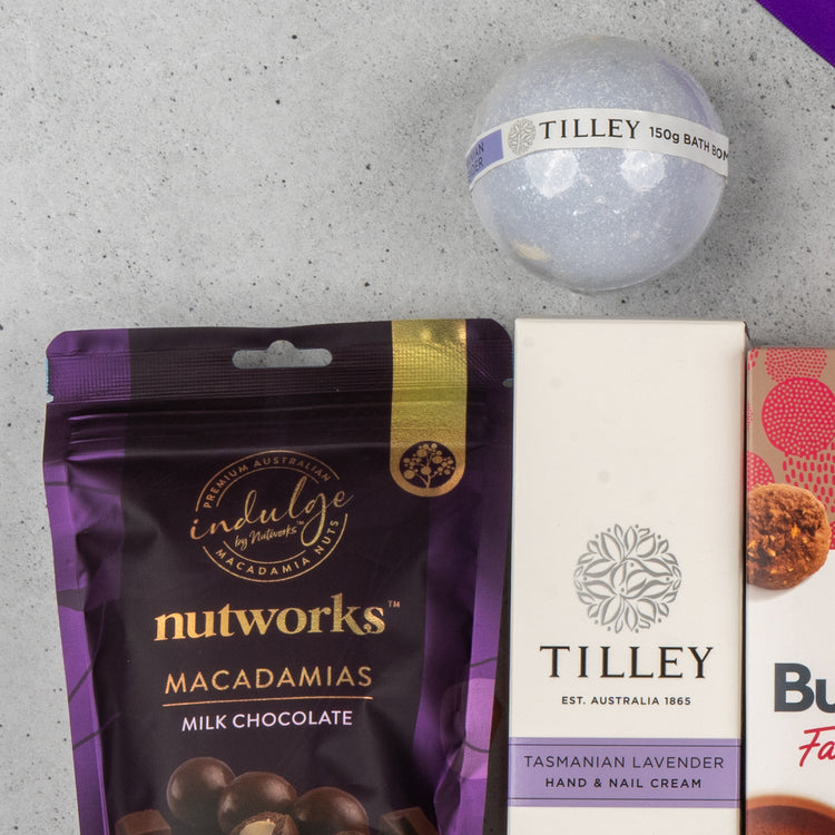 A close-up of The Hamper Boutique Co Tea Lover's Essentials Hamper, displayed on a light grey surface.