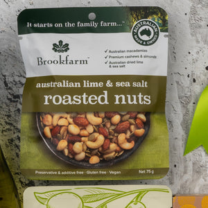 A Gourmet Treats Gift Hamper by The Hamper Boutique Co, featuring a bowl of mixed nuts on the front. The package highlights that the product is vegan, gluten-free, and preservative-free.
