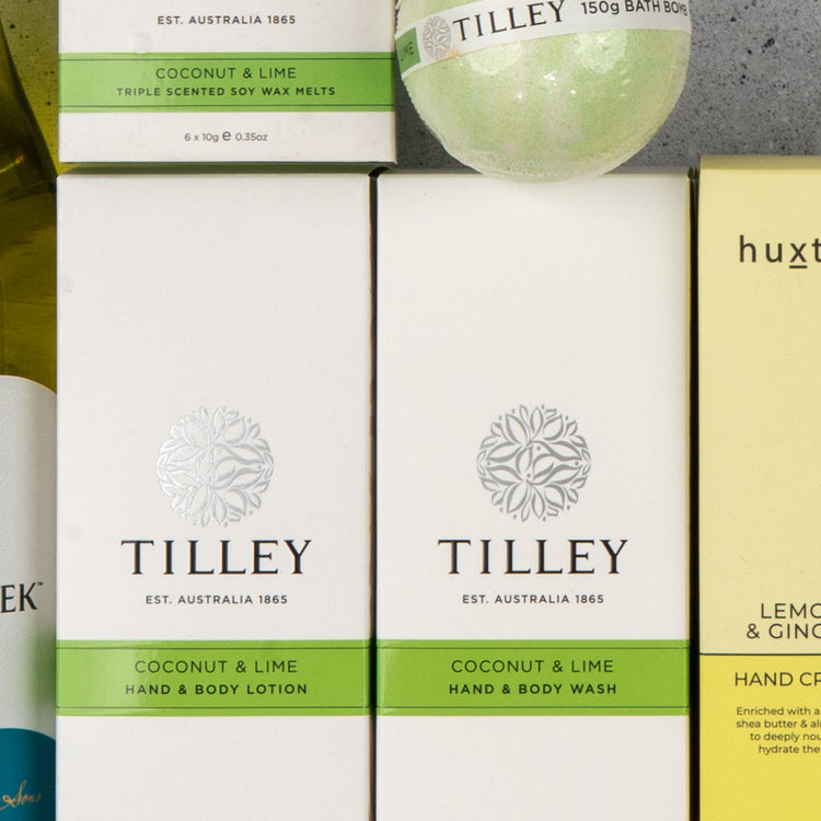 Close-up of The Hamper Boutique Co's White Wine and Self-Care box on a gray surface.