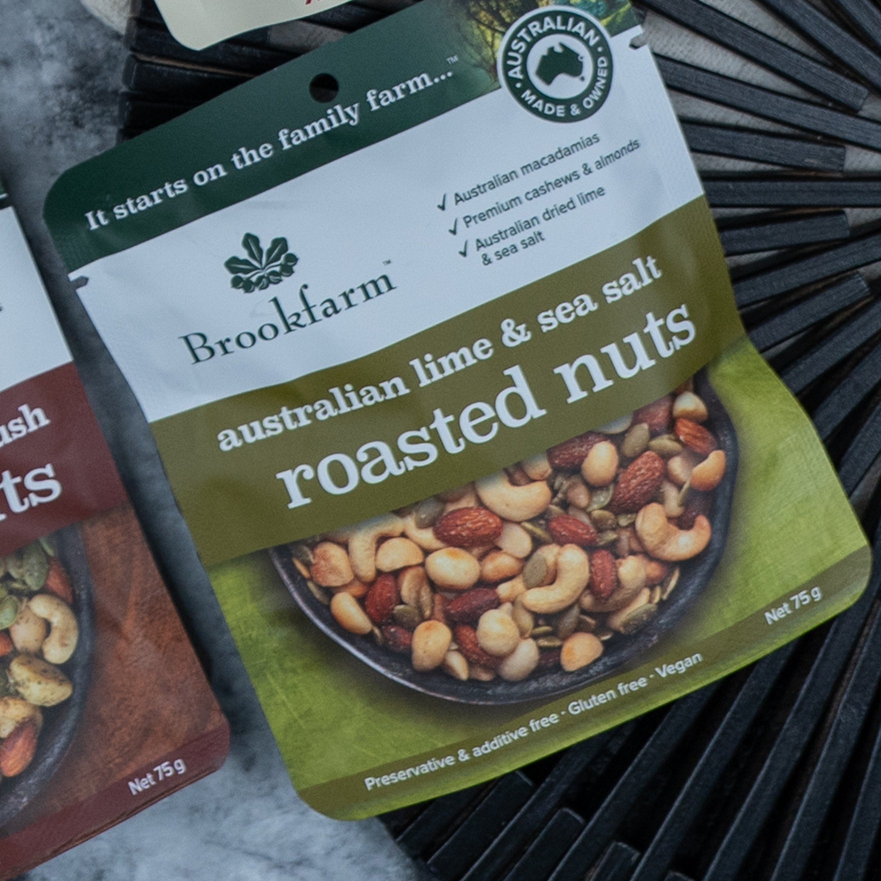 A packet of mixed nuts from The Hamper Boutique Co’s Gourmet Experience Hamper, featuring Australian lime & sea salt flavor. The 75g pack is preservative free, additive free, gluten free, and vegan, with the mix shown on the front.