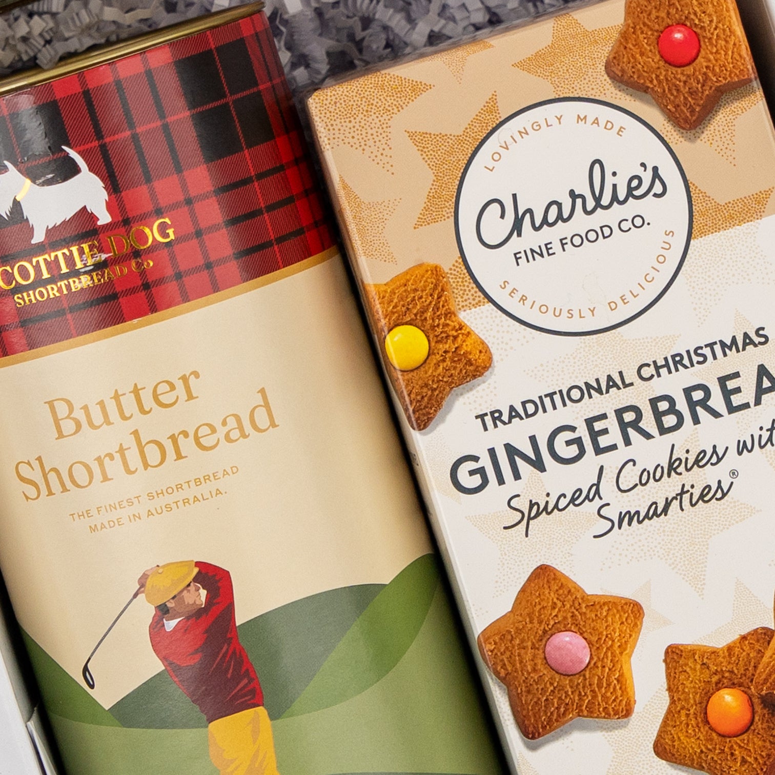 Two Sweet Traditions boxes by The Hamper Boutique Co: one features Butter Shortbread with a golfer illustration, the other has Gingerbread Spiced Cookies with Smarties, decorated with stars and cookie images.