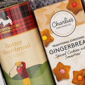Two Sweet Traditions boxes by The Hamper Boutique Co: one features Butter Shortbread with a golfer illustration, the other has Gingerbread Spiced Cookies with Smarties, decorated with stars and cookie images.