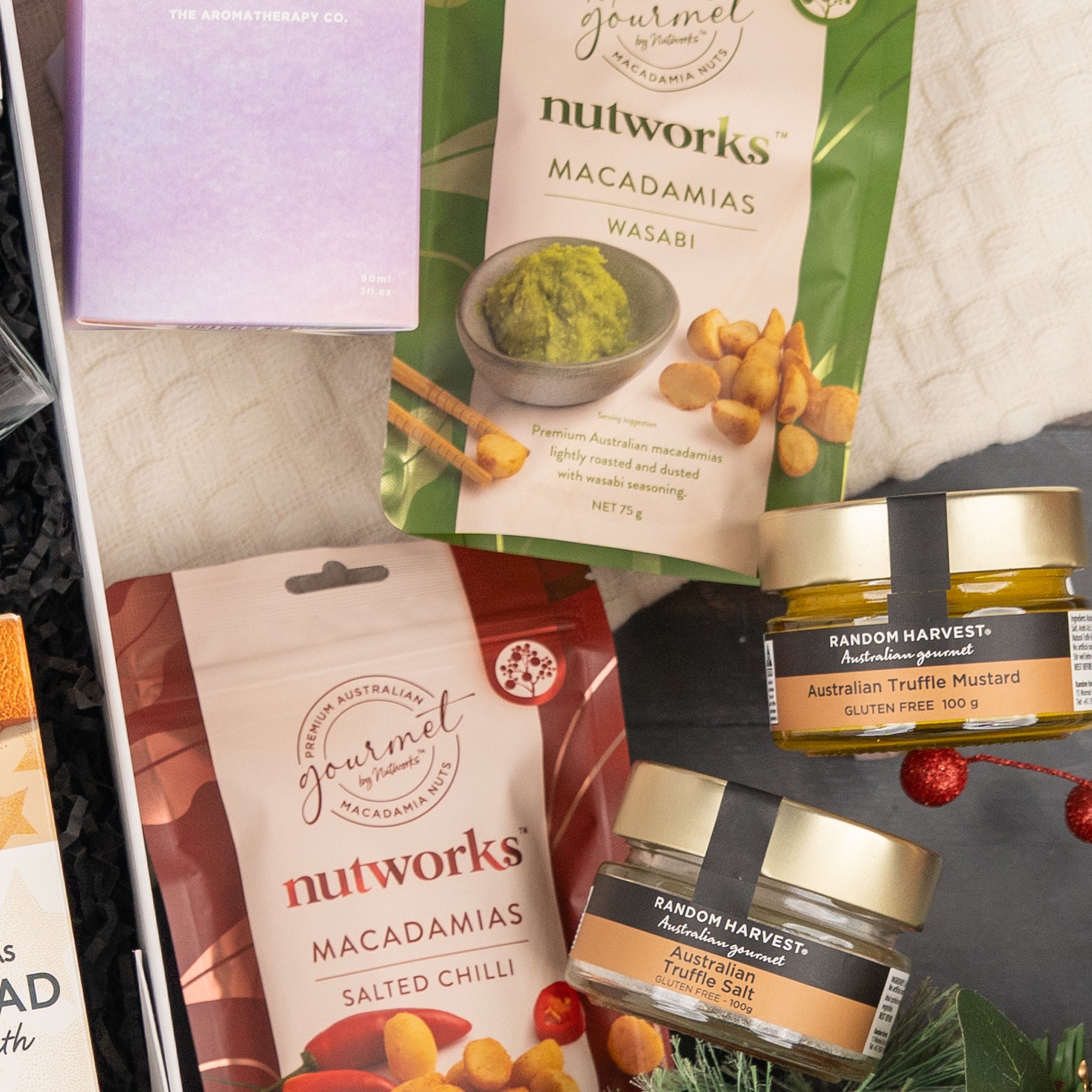 The Whisky Celebration Extravaganza by The Hamper Boutique Co includes wasabi and salted chilli Nutworks macadamias, two jars of Australian truffle mustard, plus assorted gourmet treats beautifully arranged.