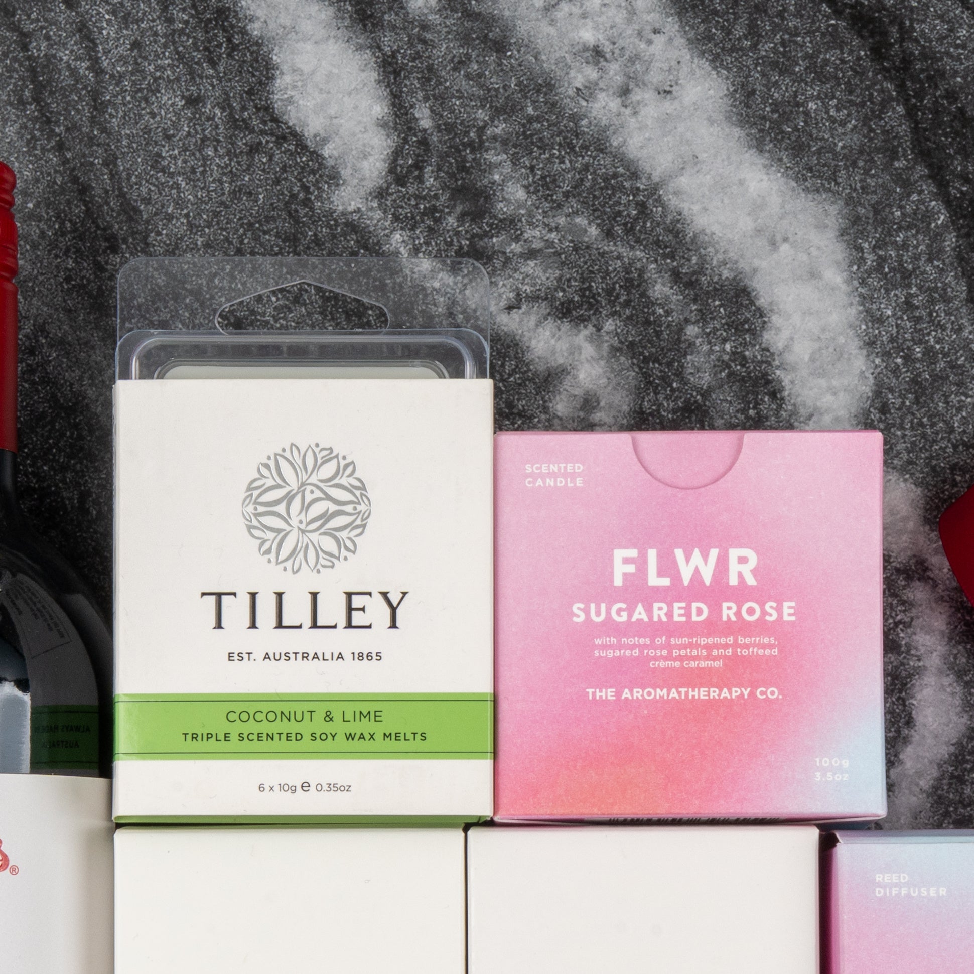 A Penfolds Spa and Indulgence Hamper by The Hamper Boutique Co sits on a marble surface, with other products partially visible nearby.