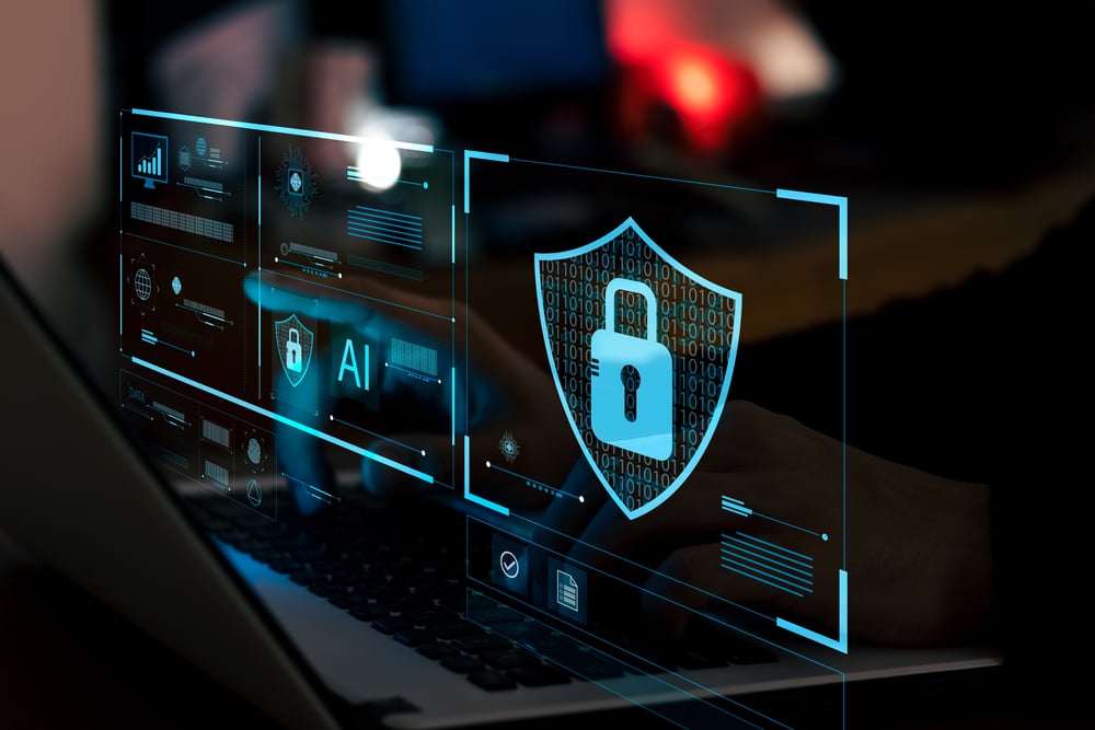 A person typing on a laptop with a digital padlock and shield overlay