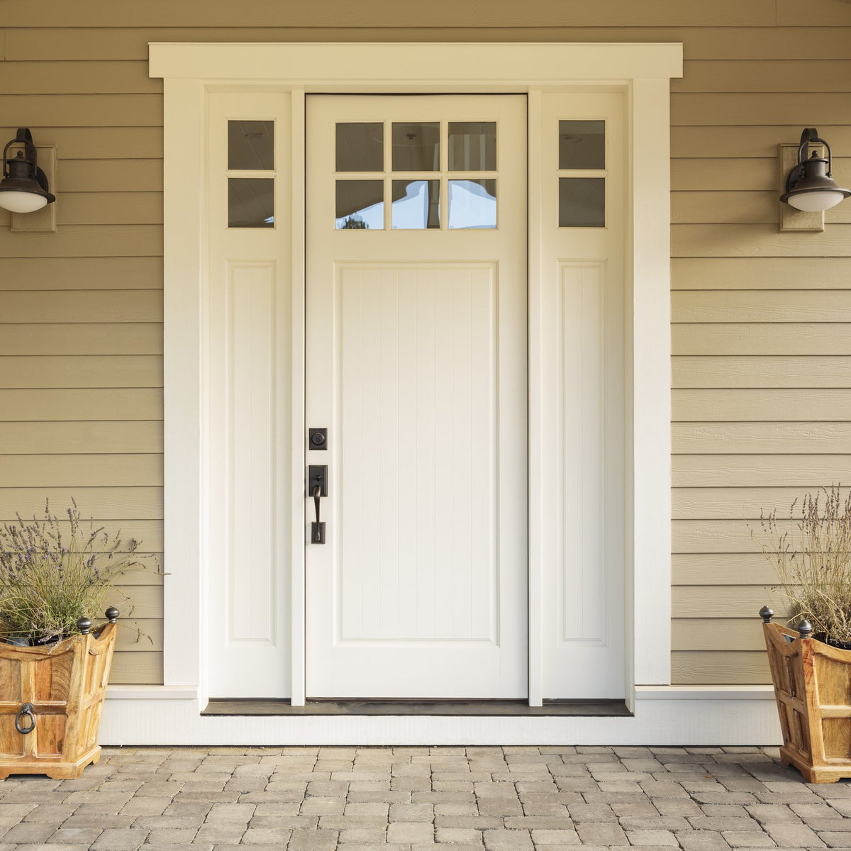 A white front door with flower pots