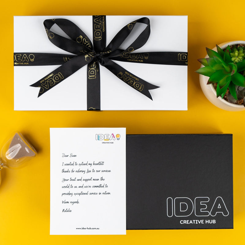 Branded corporate gift box with a printed ribbon and message card
